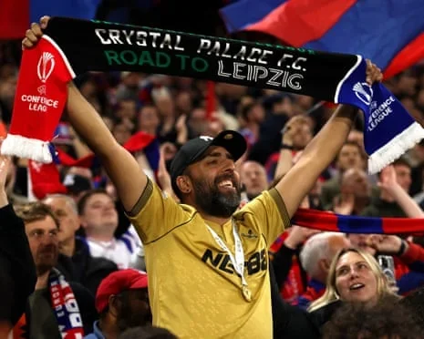 A Crystal Palace fans with a 'road to Leipzig' scarf.