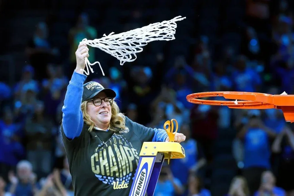 UCLA head coach Cori Close celebrates by swinging the net after cutting it off the rim after winning the NCAA Tournament in April.